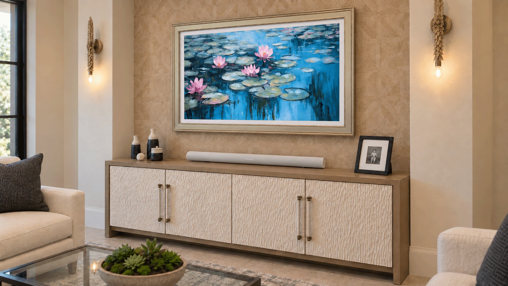 The Frame in Art Mode with water lilies, a champagne bezel, and a white Sonos bar on a living-room credenza